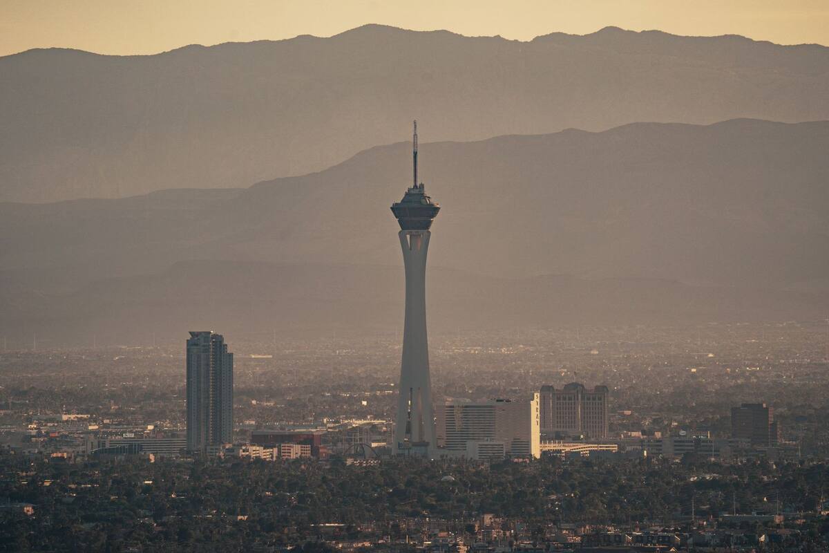The Las Vegas skyline and Stratosphere tower with the mountains behind, at golden hour
